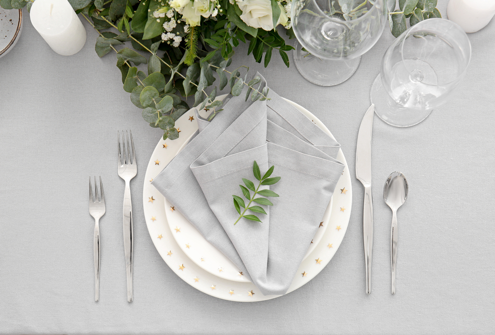 Formal place setting grey napkin on gold doted china