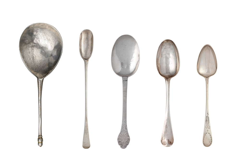 A collage of antique spoons on a white background