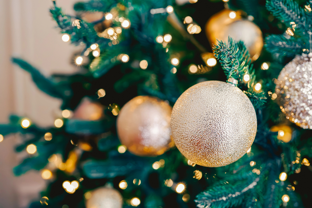 Gold Christmas ornaments adorning a beautiful tree