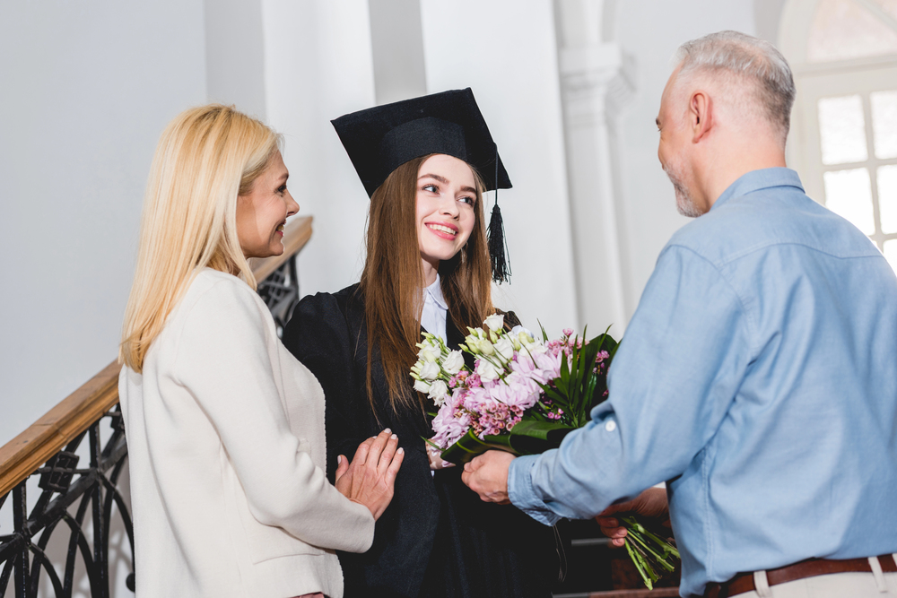Daughter graduating school in front of family
