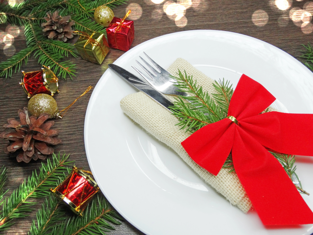 A place setting wrapped in red bow