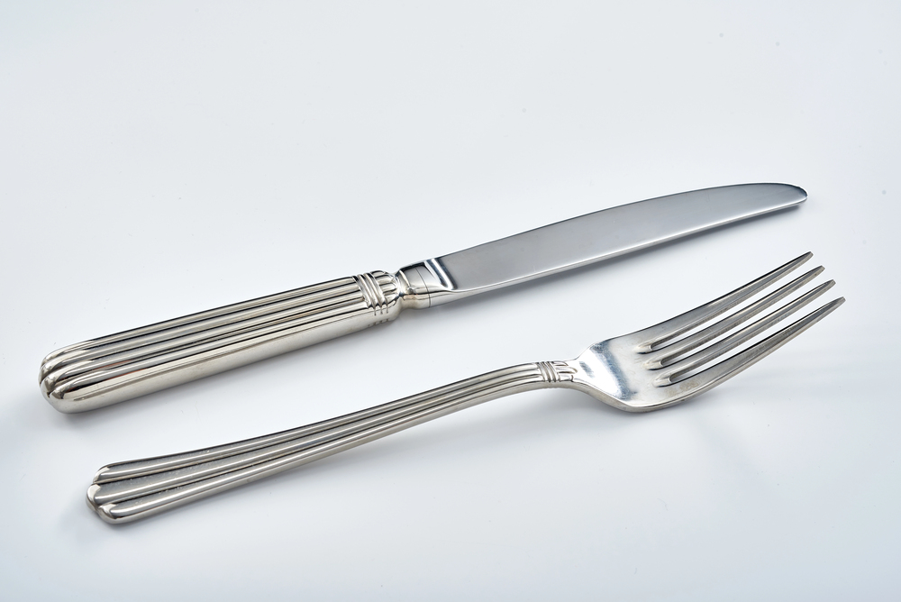 An Art Deco Fork and Knife on white table
