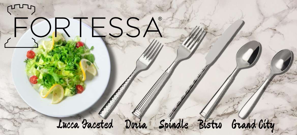 Fortessa flatware in various patterns on marble background next to salad plate.