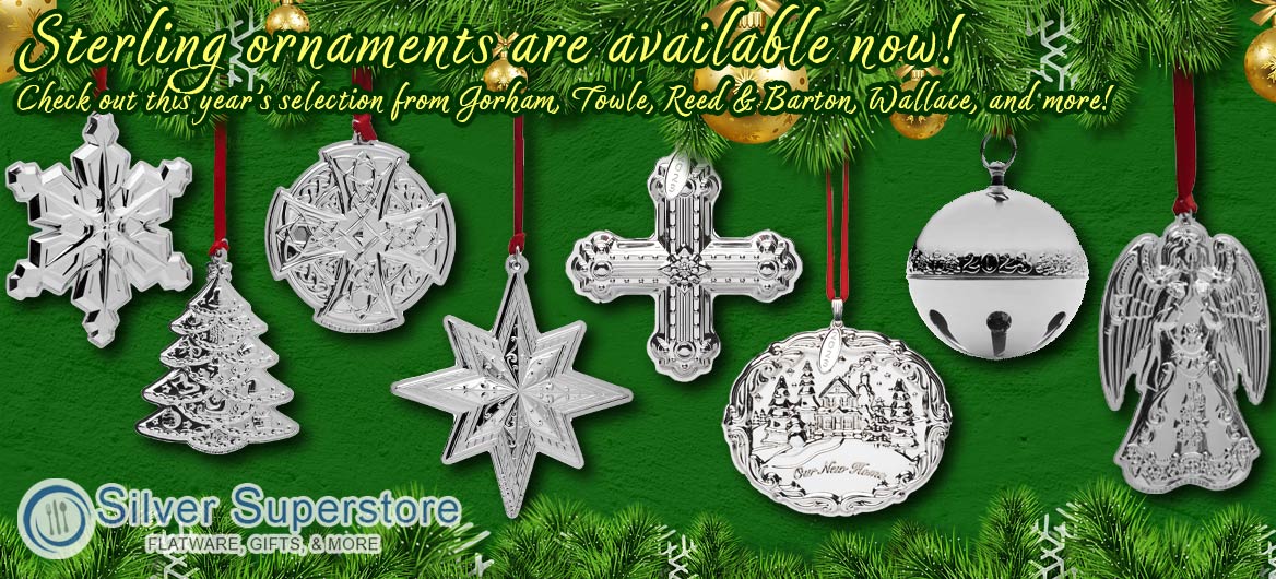 Green background with evergreen tree branches boardering the top and bottom. Displayed are a series of silver ornaments (Snowflake, Tree, Celtic Symbol, Star, Cross, Plate featuring a house that reads 'Our New Home', Sleighbell, and Angel) hanging from red strings. Text reads 'Sterling Ornaments are available now! Check out this year's collection from Gorham, Towle, Reed & Barton, Lenox, and more.' Silver Superstore logo is displayed in bottom left corner.
