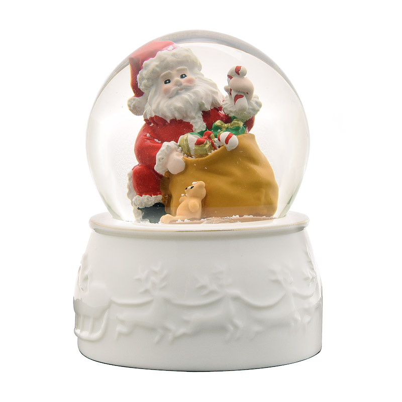 White porcelain bottom Snowglobe featuring Santa opening presents